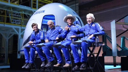 FILE - Oliver Daemen, from left, Mark Bezos, Jeff Bezos, founder of Amazon and space tourism company Blue Origin, and Wally Funk, right, participates in a post launch briefing where they discussed their flight experience aboard the Blue Origin New Shepard rocket at its spaceport near Van Horn, Texas, on July 20, 2021. The Federal Aviation Administration said Friday, Dec. 10, 2021, they are no longer present commercial astronaut wings starting next year, too many people are launching into space. All 15 people who rocketed into space this year on private flights from the U.S. will still receive their wings from the FAA. (AP Photo/Tony Gutierrez, File)