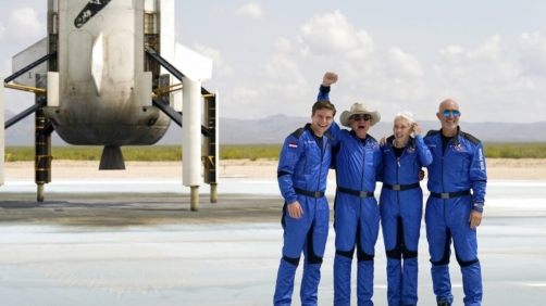 FILE - Oliver Daemen, from left, Jeff Bezos, founder of Amazon and space tourism company Blue Origin, Wally Funk and Bezos' brother Mark pose for photos in front of the Blue Origin New Shepard rocket, left rear, after their launch from the spaceport near Van Horn, Texas, Tuesday, July 20, 2021. (AP Photo/Tony Gutierrez, File)