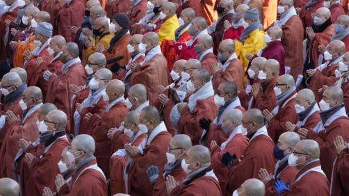 South Korean Buddhist monks pray during a rally against government's policy at the Jogye temple in Seoul, South Korea, Friday, Jan. 21, 2022. Thousands of Buddhist monks gathered to protest alleged religious discrimination by South Korean government. (AP Photo/Ahn Young-joon)