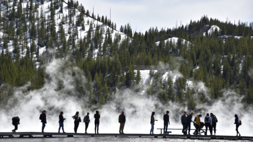 FILE - Visitors are seen at Grand Prismatic Spring in Yellowstone National Park, Wyo. on May 1, 2021. Yellowstone Superintendent Cam Sholly says officials want wants to use the park's 150th anniversary this year to recognize the many American Indian nations that lived in the area for thousands of years before the park was created. (AP Photo/Iris Samuels,File)