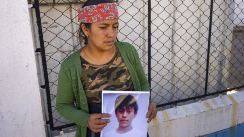 Maria Sipac Coj holds a portrait of her son Pascual Melvin Guachiac in Tzucubal, Guatemala, Wednesday, June 29, 2022. Pascual and his cousin Wilmer Tulul, both 13, were among the dead discovered inside a tractor-trailer near auto salvage yards on the edge of San Antonio, Texas, on Monday, in what is believed to be the nation's deadliest smuggling episode on the U.S.-Mexico border. (AP Photo/Moises Castillo)
