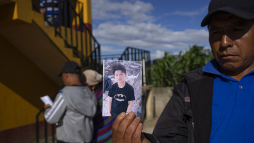 A man shows a portrait of Wilmer Tulul, in Tzucubal, Guatemala, Wednesday, June 29, 2022. Wilmer and his cousin Pascual, both 13, were among the dead discovered inside a tractor-trailer near auto salvage yards on the edge of San Antonio, Texas, on Monday, in what is believed to be the nation's deadliest smuggling episode on the U.S.-Mexico border. (AP Photo/Moises Castillo)