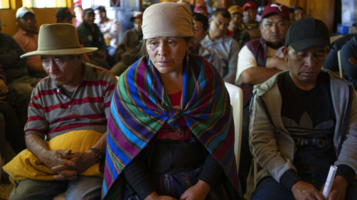 Magdalena Tepaz, center, and Manuel de Jesus Tulul, right, parents of Wilmer Tulul, wait for the start of a community meeting in Tzucubal, Guatemala, Wednesday, June 29, 2022.  Wilmer and his cousin Pascual, both 13, were among the dead discovered inside a tractor-trailer near auto salvage yards on the edge of San Antonio, Texas, on Monday, in what is believed to be the nation's deadliest smuggling episode on the U.S.-Mexico border. (AP Photo/Moises Castillo)