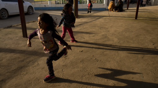Children play as their parents attend a community meeting in Tzucubal, Guatemala, Wednesday, June 29, 2022. Tzucubal is the hometown of Pascual Melvin Guachiac and Wilmer Tulul, both 13, who were among the dead discovered inside a tractor-trailer on the edge of San Antonio, Texas, on Monday, in one of the nation's deadliest smuggling episode on the U.S.-Mexico border. (AP Photo/Moises Castillo)