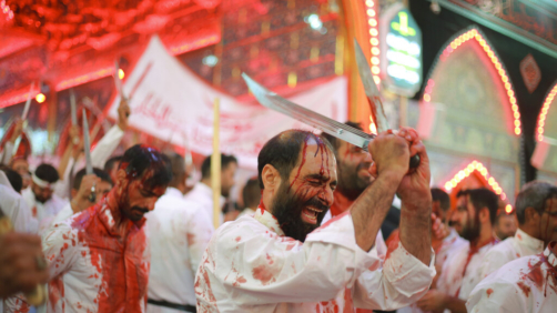 Iraqi Shiites perform self-flagellation as they attend the Ashoura ceremonies in Karbala, Iraq, Monday, Aug. 8, 2022. Ashoura marks the death of Husayn ibn Ali, a grandson of the Islamic prophet Muhammad, and members of his immediate family in the Battle of Karbala. (AP Photo/Anmar Khalil)