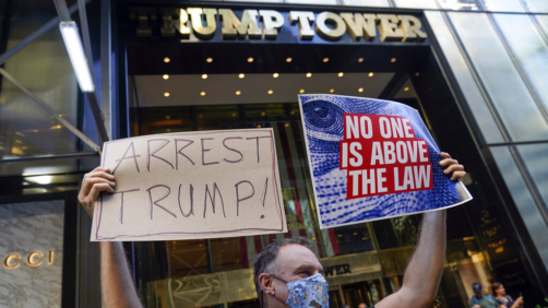 A protester stands in front of Trump Tower in New York, Tuesday, Aug. 9, 2022. The FBI's search of Donald Trump's Mar-a-Lago estate marked a dramatic and unprecedented escalation of the law enforcement scrutiny of the former president, but the Florida operation was just one part of one investigation related to Trump and his time in office. (AP Photo/Seth Wenig)