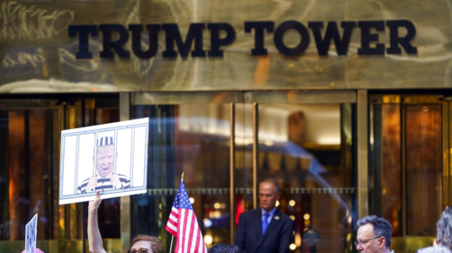 Protesters stand in front of Trump Tower in New York, Tuesday, Aug. 9, 2022. The FBI search of Donald Trump's Mar-a-Lago estate marked a dramatic and unprecedented escalation of the law enforcement scrutiny of the former president, but the Florida operation was just one part of one investigation related to Trump and his time in office. (AP Photo/Seth Wenig)