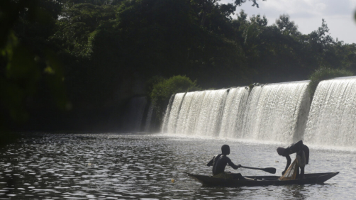 Fishermen paddle their canoe near a dam that sources the sacred river in Esa-Odo Nigeria, on Saturday, May 28, 2022. (AP Photo/Sunday Alamba)