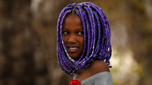 Sophia Fernandes, a member of the Kalunga quilombo, the descendants of runaway slaves, dons traditional afro braids, during the culmination of the week-long pilgrimage and celebration for the patron saint 