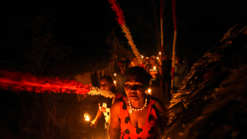 A member of the Kalunga quilombo, the descendants of runaway slaves, take part in the candlelight procession during the culmination of the week-long pilgrimage and celebration for the patron saint 