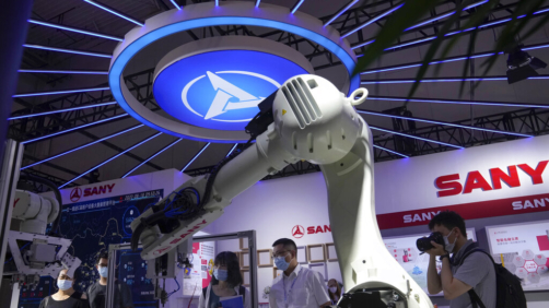 Visitors look at a Chinese-made industrial robot at the World Robot Conference at the Yichuang International Conference and Exhibition Centre in Beijing, Thursday, Aug. 18, 2022. (AP Photo/Andy Wong)
