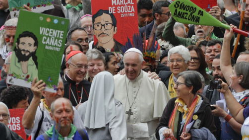 Pope Francis smiles to a nun as he walks in procession on the occasion of the Amazon synod, at the Vatican, Monday, Oct. 7, 2019. Pope Francis opened a three-week meeting on preserving the rainforest and ministering to its native people as he fended off attacks from conservatives who are opposed to his ecological agenda. (AP Photo/Andrew Medichini)