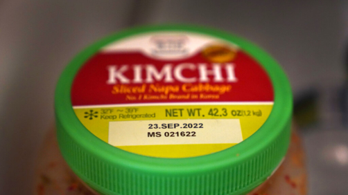 A date is stamped on a container of Kimchi, Sunday, Aug. 21, 2022, in Chicago.  As awareness grows around the world about the problem of food waste, one culprit in particular is drawing scrutiny: “best before” labels. Manufacturers have used the labels for decades to estimate peak freshness. Unlike “use by” labels, which are found on perishable foods like meat and dairy, “best before” labels have nothing to do with safety and may encourage consumers to throw away food that’s perfectly fine to eat.  (AP Photo/Charles Rex Arbogast)