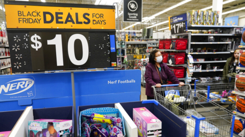 Signs advertise Black Friday deals at a Walmart in Secaucus, N.J., Tuesday, Nov. 22, 2022. (AP Photo/Seth Wenig)