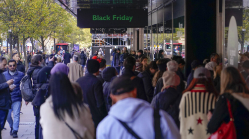 People queue outside a retail shop in Oxford Street on Black Friday, in London, Friday, Nov. 25, 2022. (AP Photo/Alberto Pezzali)
