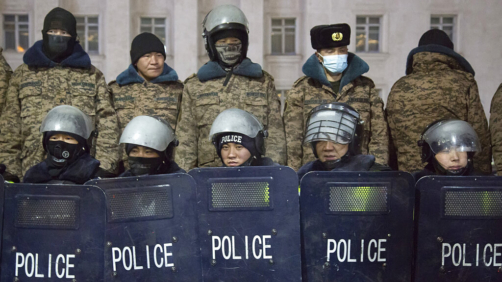 Police form up behind shields during a protest on Sukhbaatar Square in Ulaanbaatar in Mongolia on Monday, Dec. 5, 2022. Protesters angered by allegations of corruption linked to Mongolia's coal trade with China have stormed the State Palace in the capital, demanding dismissals of officials involved in the scandal. (AP Photo/Alexander Nikolskiy)