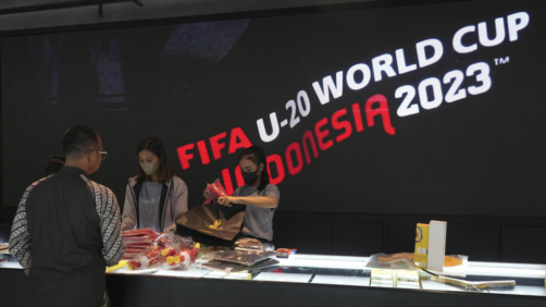 Shop attendants serve a customer who shop for FIFA U-20 World Cup official merchandises at a shopping mall in Jakarta, Indonesia, Friday, March 31, 2023. Indonesian soccer players and fans reacted with tears and outrage after the country was stripped of hosting rights for the Under-20 World Cup only eight weeks before the start of the tournament amid political turmoil over Israel’s participation, leaving Indonesian soccer at risk of further sanctions. (AP Photo/Tatan Syuflana)