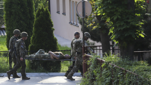 A KFOR soldier is carried on a stretcher after suffering an injury during clashes with Kosovo Serbs in the town of Zvecan, northern Kosovo, Monday, May 29, 2023. Ethnic Serbs in northern Kosovo clashed with troops from the NATO-led KFOR peacekeeping force as they tried to take over the offices of one of the municipalities where ethnic Albanian mayors took up their posts last week, with the help of the authorities. (AP Photo/Bojan Slavkovic)