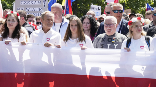 Participants join an anti-government march led by the centrist opposition party leader Donald Tusk, second left, and Lech Walesa, second right, who along with other critics accuse the government of eroding democracy, in Warsaw, Poland, Saturday June 4, 2023. The march is being held on the 34th anniversary of the first democratic elections in 1989 after Poland emerged from decades of communist rule. (AP Photo/Czarek Sokolowski)
